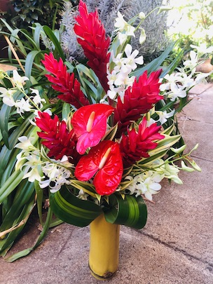 anthurium and orchids in bamboo vase